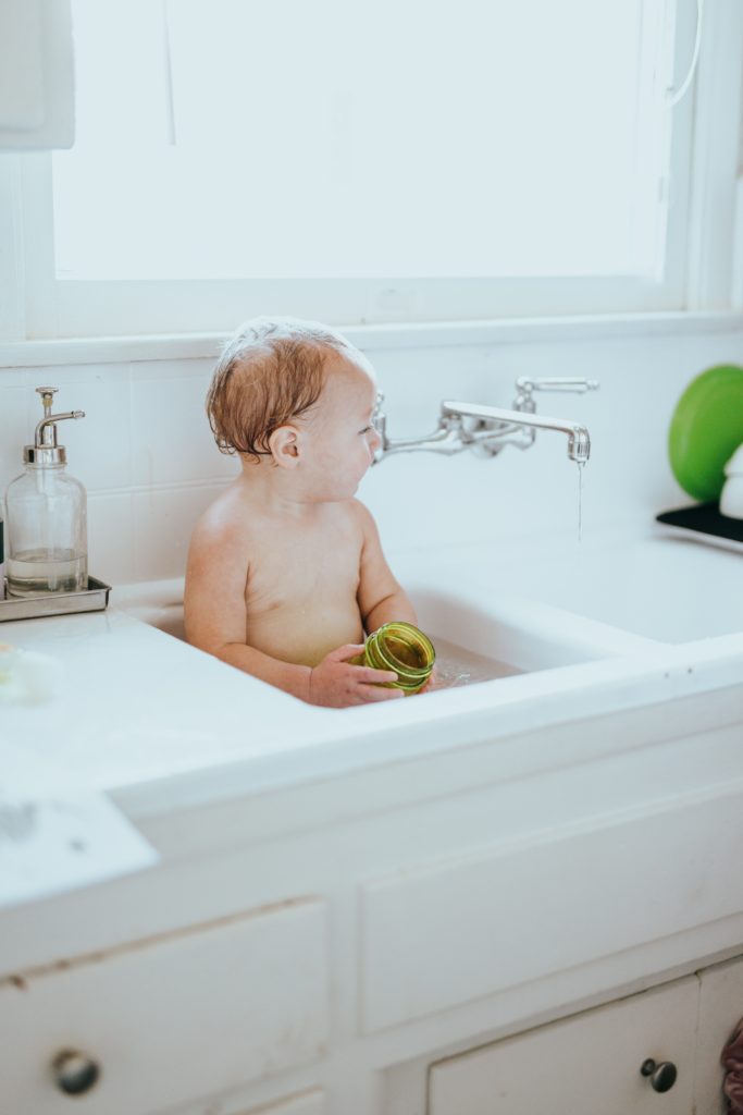 A photo of a baby in the bath, and how often you should give your baby a bath